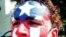 Un puertorriqueño luce la bandera de Puerto Rico pintada en su rostro en uno de los festivales boricuas en la ciudad de Orlando en Florida el 7 de mayo de 2004. Los puertorriqueños radicados en la ciudad de Orlando son la comunidad hispana más grande en l