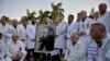 Médicos cubanos de la brigada internacional Henry Reeve posan con un retrato de Fidel Castro antes de partir a Italia, en marzo pasado. (Yamil LAGE / AFP)