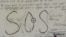 La carta enviada en una botella por los balseros del faro. 