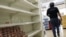 Un cliente recorre un pasillo con estanterías desabastecidas en un supermercado de Caracas (Venezuela).